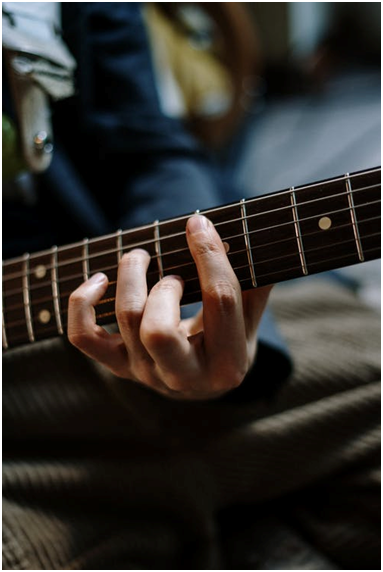 Checking the guitar’s fretboard